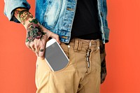 Mobile phone in a tattooed man's pocket