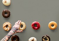 Hands selecting a variety of donut flavour