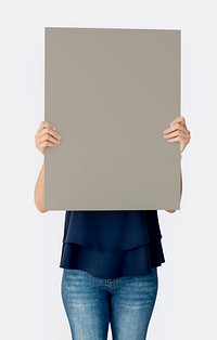 Woman holding blank banner cover face studio portrait