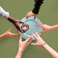 Group of Hands reaching for a donut