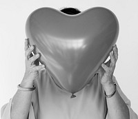 People Faces Covered with Heart Balloons