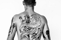 Rear view of a man with tattoo on his back