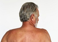 Man standing topless and posing for photoshoot