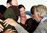 Group of diverse people arms around others