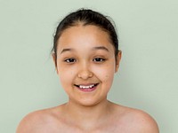 Little girl smiling bare chest studio portrait