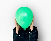 Woman close up holding balloon and posing for photoshoot