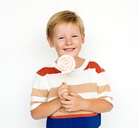 Happy little boy smiling with lollipop 
