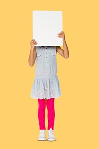Little girl holding blank placard covering her face