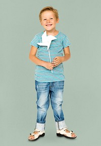 Happiness little boy smiling and holding pinwheel studio portrait