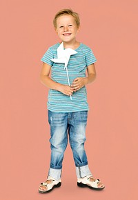 Happiness little boy smiling and holding pinwheel studio portrait
