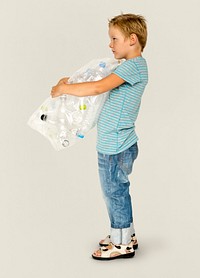 Ecology little boy holding bag of plastic bottle for recycle