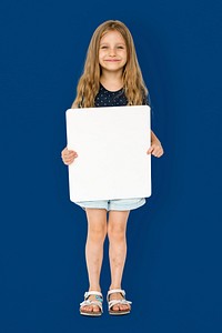 Little girl smiling and holding blank placard