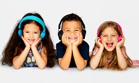 Diverse Group Of Kids Lying and Listen to Music In a Headphones