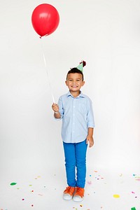 Kid happiness with balloon on studio shoot