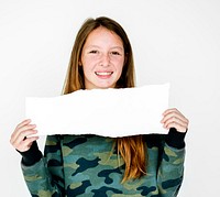 Young adult girl holding blank banner studio portrait