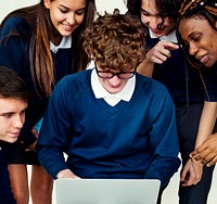 Group of diverse students checking on a laptop