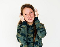 Young adult girl smiling and listening music studio portrait