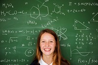 Young Student in Uniform with Chalk Board Background Portrait
