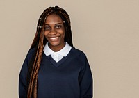 Portrait studio shoot of schoolgirl in uniform with smiling
