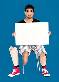 Disability Young Man with Prosthesis Leg Holding Blank Paper Board Studio Portrait