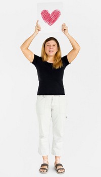 Caucasian woman full body holding board with heart sign