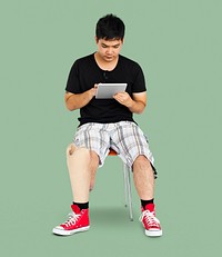 Disability Young Man with Prosthesis Leg Using Tablet Studio Portrait