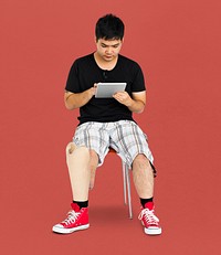 Disability Young Man with Prosthesis Leg Using Tablet Studio Portrait