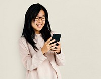 Young adult asian girl smiling and using mobile phone