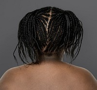 Little african girl shirtless studio portrait in rear view