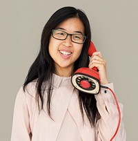 Asian girl talking by phone studio portrait