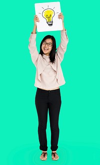Young adult asian girl smiling and holding light bulb banner