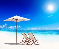 Deck chairs on white sand beach.