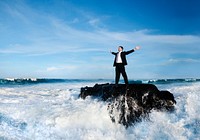 Businessman standing in a wavy sea