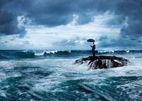 Businessman with an umbrella at a stormy ocean