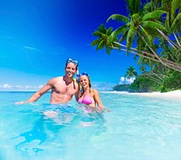 Couple with scuba gear in paradise
