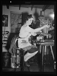 Mrs. Hazel Wheeler places screws into electric terminals. Mrs. Wheeler who lives in Bantam with her husband, a machinist at the Warren MacArthur Plant there, was in a happy state of mind when this picture was taken. She had just learned definitely that all was well with her son, attached to a naval medical unit at Pearl Harbor during the December 7 attack. Sourced from the Library of Congress.