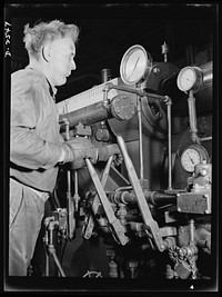 Conversion. Copper and brass processing. This worker is at the controls of an extruding machine, a powerful piece of apparatus in a brass and copper mill that pushes billets of metal usually heated red hot, through a die to form rods, tubes, angles, channels and other shapes. Chase Brass and Copper Company, Euclid, Ohio. Sourced from the Library of Congress.