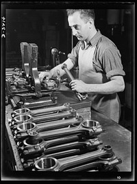 Halftrac scout cars. Perfectly balanced sets of connecting rods mean better engine performance for the Army's new halftrac scout cars. The man who weighs the rods must adhere to the very close tolerances set up for every operator in the big Midwestern plant in which he works. White Motor Company, Cleveland, Ohio. Sourced from the Library of Congress.