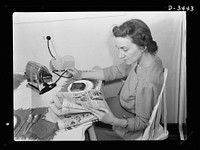What's wrong with this picture? Only that the lady is ruining her electric cord by disconnecting the toaster the wrong way. Don't pull cords from irons or toasters: disconnect them gently at the wall socket. Sourced from the Library of Congress.