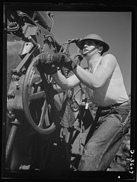 Fort Story coast defense. One of Uncle Sam's fighting men at Fort Story, Virginia adjusts the range on one of the giant guns which line the shore. Sourced from the Library of Congress.