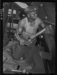 Manpower. African American shipyard workers. Skills which contributed to America's success in World War I are vital to our efforts in World War II. This riveter is a veteran employee in a large Eastern shipyard. Another African American broke the world record for riveting in World War I. Federal Shipbuilding and Drydock Corporation. Kearny, New Jersey. Sourced from the Library of Congress.