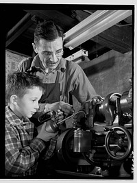 Subcontracting. Passaic home workshop pool. George Carell's seven-year-old son likes to watch his father produce essential war equipment in his Paissaic, New Jersey home workshop. Mr. Carell belongs to a subcontract pool organized by the Howe Machinery Company of his city. Sourced from the Library of Congress.