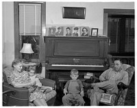 De Land pool. La Roe shop. The La Roe family of Eustis, Florida, after a day's work for the De Land pool. Left is Mrs. La Roe with her two-year-old granddaughter, next is four-year-old Eugene, Clarence La Roe's son, and Mr. La Roe. Sourced from the Library of Congress.