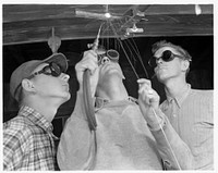 De Land pool. Aircraft construction class. The flame of welding torches has replaced the soft lights of a nightclub in Daytona Beach, Florida, which has been taken over for a vocational school to train war workers for Florida's pooling program. Pictured above is C.C. Gravelge, welding instructor, showing one of his classes the difficult art of overhead welding in preparation for their initiation into aircraft welding jobs on the De Land pool's war contract. Sourced from the Library of Congress.