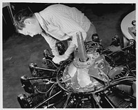 De Land pool. Aircraft construction class. Daytona Beach, Florida high school students are making a record among the vocational schools of the state in the speed with which they are picking up the mechanics of repairing airplane motors. Dewey Stewart, nineteen, is checking the valve adjustment on a Wright J-5 in the motor room of the Volusia County Vocational School, operating on the dance floor of a revamped nightclub. Sourced from the Library of Congress.