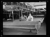 Production. Willow Run bomber plant. Checking almost-completed wing structure with blueprints, engineers at the great Willow Run bomber plant determine next steps to be taken before the wings leave the assembly line. Ford plant, Willow Run. Sourced from the Library of Congress.