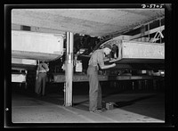 Production. Willow Run bomber plant. African American worker at Willow Run installs screws in wing segment of a bomber. Note underside of wing, above. Ford plant, Willow Run. Sourced from the Library of Congress.