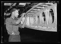 Production. Willow Run bomber plant. An African American worker at the giant Willow Run bomber plant installs screws in one end of a wing segment. Sourced from the Library of Congress.