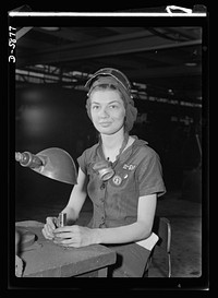 Women in industry. Aircraft motor workers. A million dollar baby, not in terms of money but in her value to Uncle Sam, twenty-one-year-old Eunice Hancock, erstwhile five-and-ten-cent store employee, operates a compressed-air grinder in a Midwest aircraft motor plant. With no previous experience, Eunice quickly mastered the techniques of her war job and today is turning out motor parts with speed and skill. Note protective mask and visor, two vital safety accessories. Sourced from the Library of Congress.