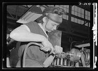 Women in industry. Aircraft motor workers. Employer resistance to the hiring of women workers in war industries is rapidly becoming a thing of the past, and this young employee of a Midwest aircraft motor plant embodies the reasons for this change of heart. With no previous industrial experience, she mastered the operation of this compressed-air machine in record time, and is now polishing airplane motor parts with speed and skill. Sourced from the Library of Congress.